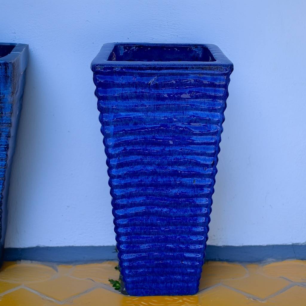 Tall, wavy ceramic planter in blue