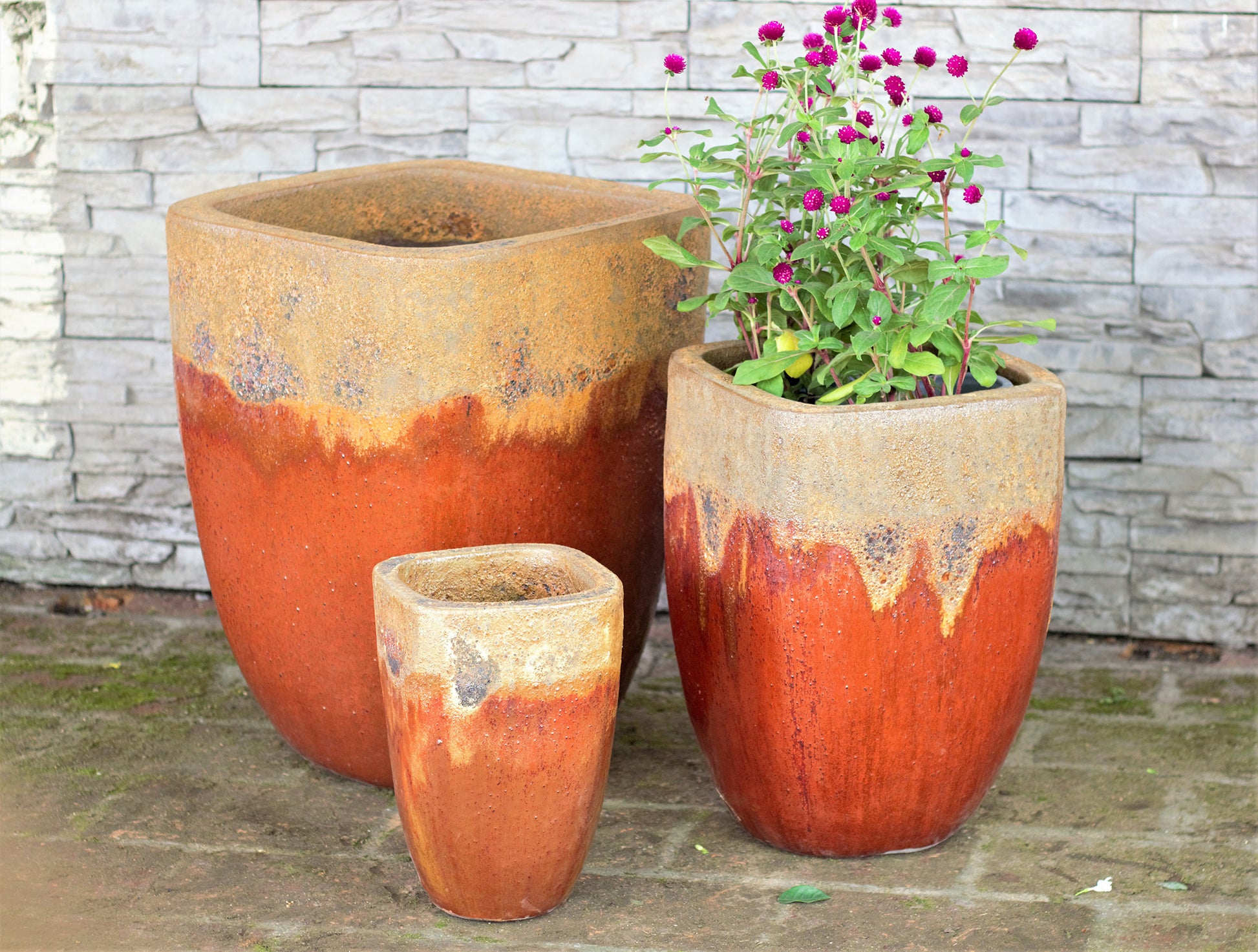 Rounded square-rim tapered planter in vibrant orange with a natural, unglazed rim for a textured contrast