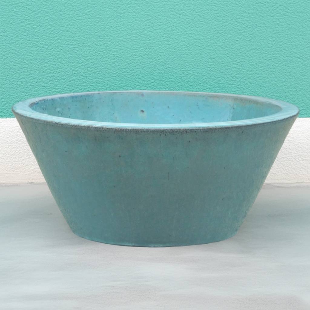 Cone-shaped ceramic low bowl planters in teal with wide rims and smooth finishes
