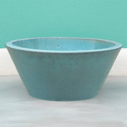 Cone-shaped ceramic low bowl planters in teal with wide rims and smooth finishes