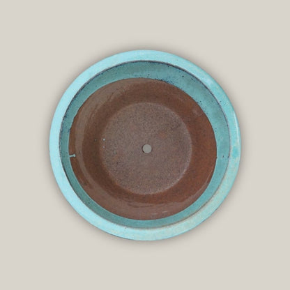 Top view of cone-shaped ceramic low bowl planters with wide rims in a vibrant teal glaze