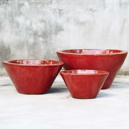 Cone-shaped, wide-rimmed ceramic low bowl planters with a glossy red glaze