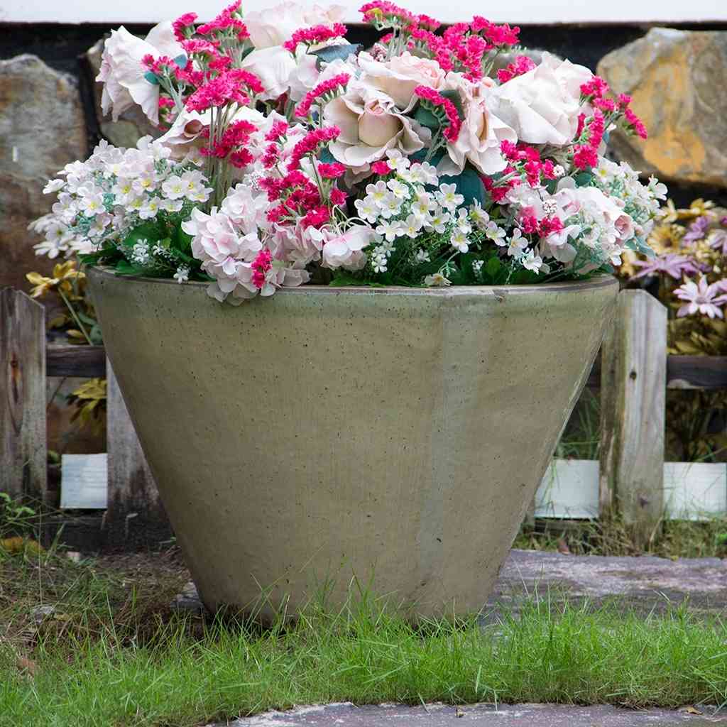 Cone-shaped low bowl ceramic planters with wide rims and a smooth glazed light tan finish
