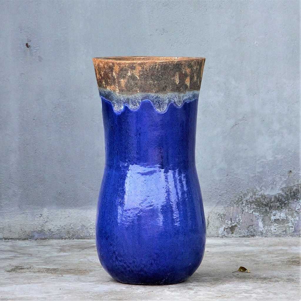 Blue ceramic planter with a rustic, unglazed rim