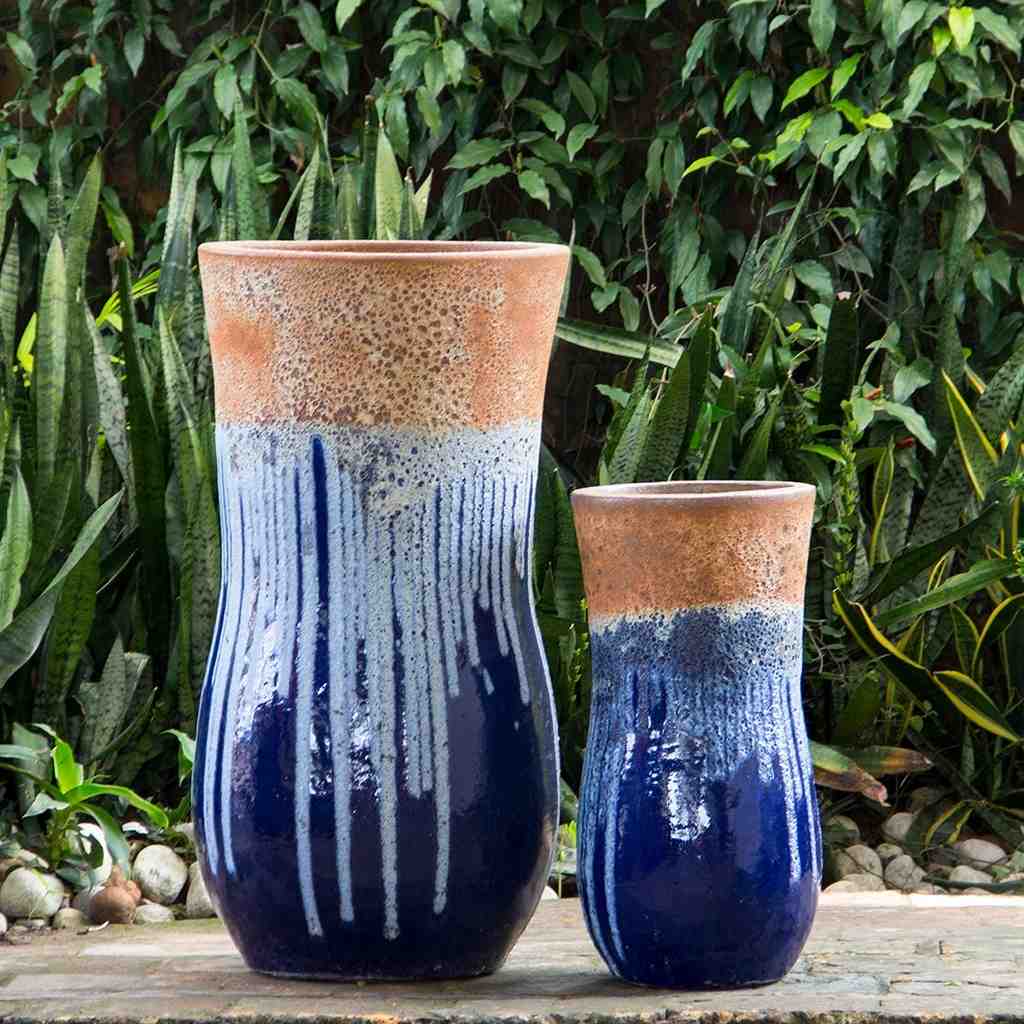 Two ceramic drip planters in dark blue glaze with a rustic, unglazed rim