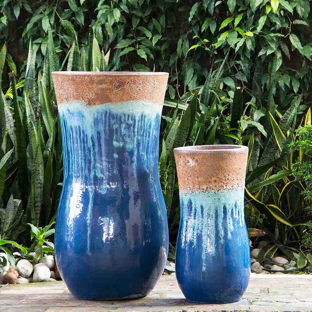 Hourglass-shaped ceramic planters with a drippy glaze effect in blue, light blue, and rust unglazed rim