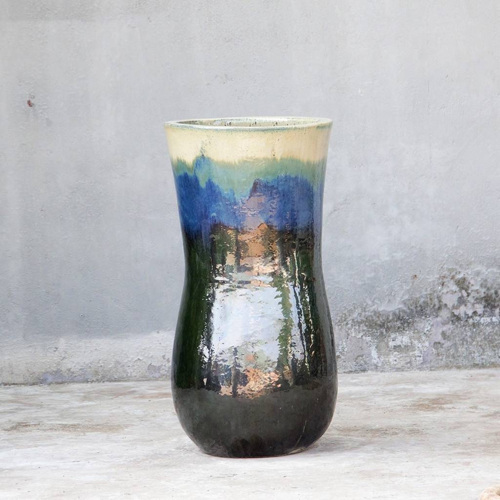 Ceramic planter with a multi-colored glaze in deep blue-green with crisp white rim