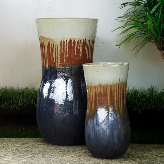 Wholesale Tall hourglass-shaped ceramic planters with a tri-color dripped glaze effect in white, brown/rust, and dark blue/grey