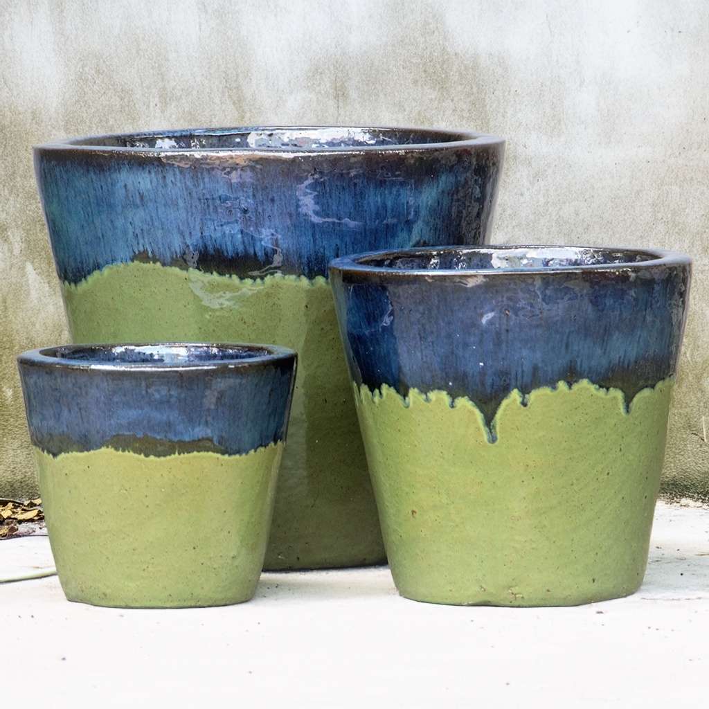 Tapered round ceramic planter in glossy apple green with a contrasting dark blue top