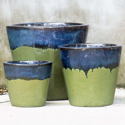 Tapered round ceramic planter in glossy apple green with a contrasting dark blue top
