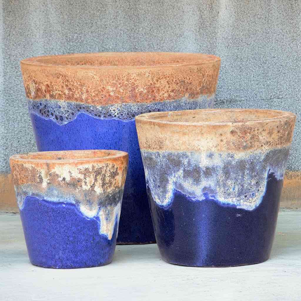 Tapered round ceramic planter in blue featuring a textured top