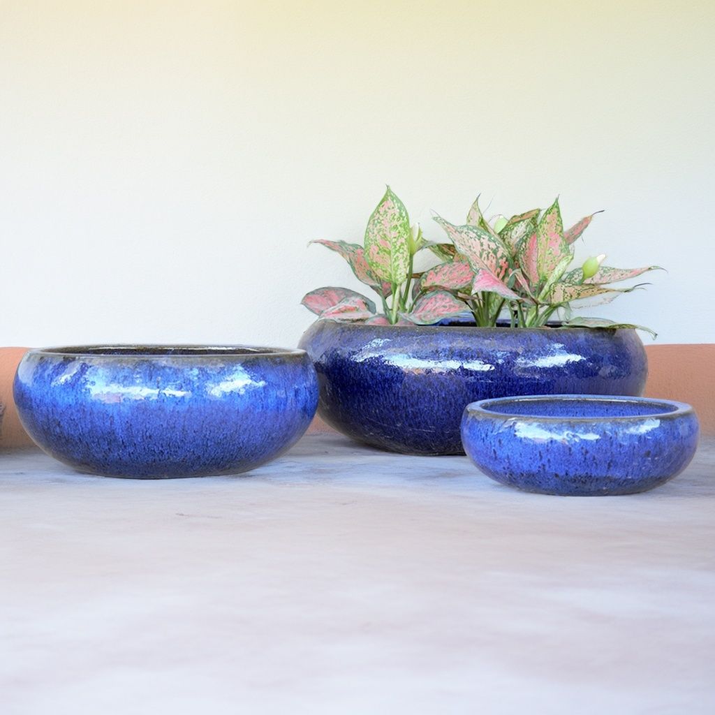 Set of 3 glazed ceramic low bowl planters in a glossy blue finish, featuring smooth curves and a sleek, modern look