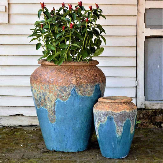 Wholesale Tall, rounded jar-style planters in blue featuring a textured rim and a distinctive dripping glaze effect