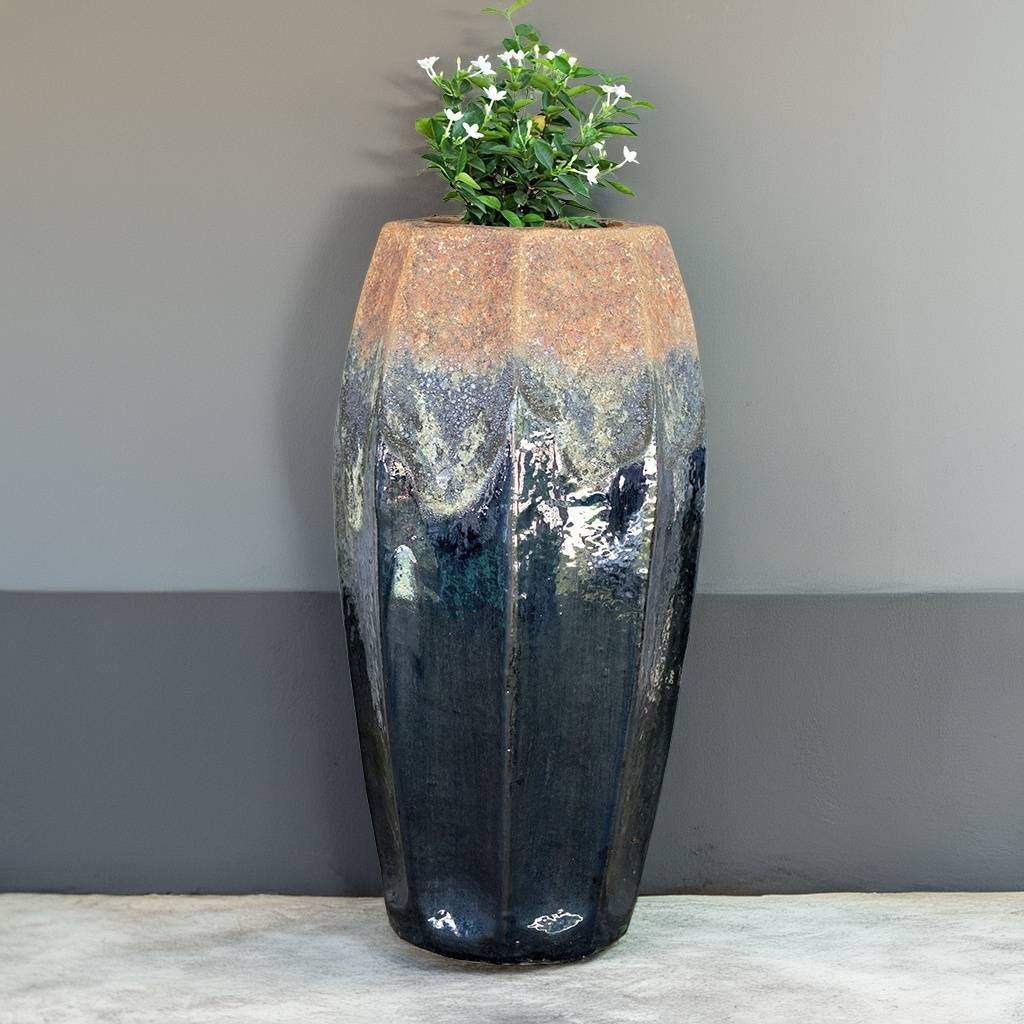Tall fluted ceramic planter in black with greyish accents and a rustic textured rim