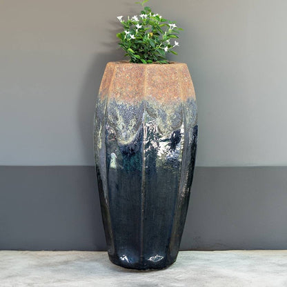 Tall fluted ceramic planter in black with greyish accents and a rustic textured rim