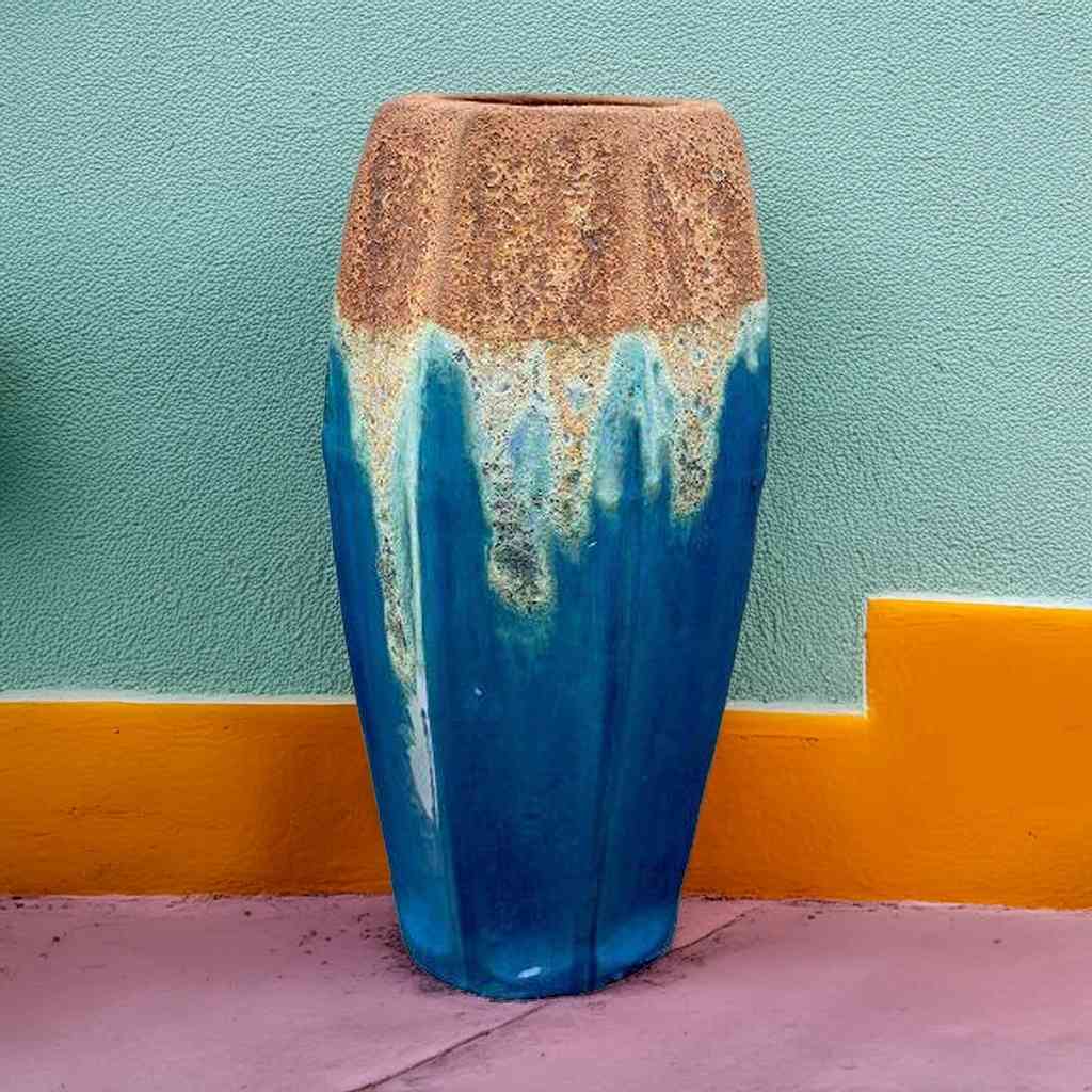 Tall fluted ceramic planters in deep blue with turquoise accents and a rustic textured rim