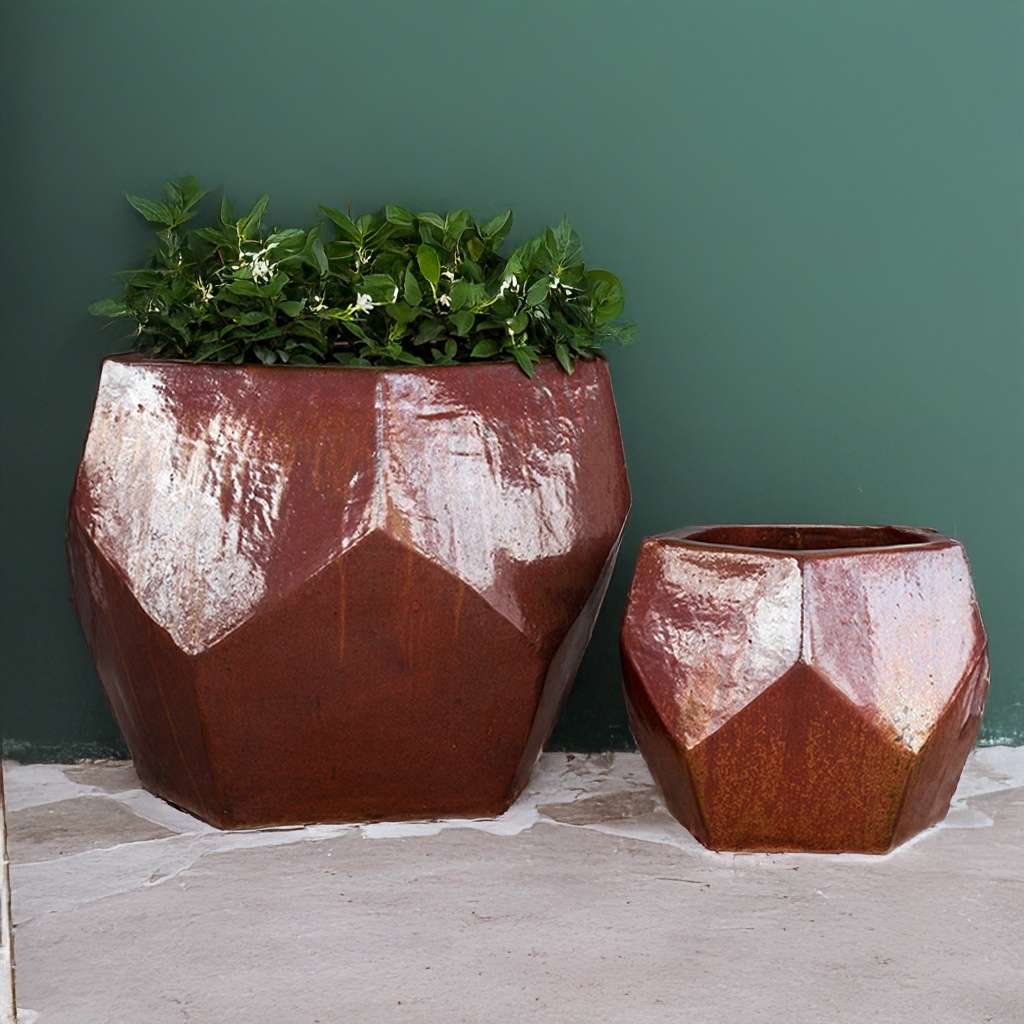 Faceted geometric polygon ceramic planter in cream with brown-red accents, featuring sharp angles and a modern design