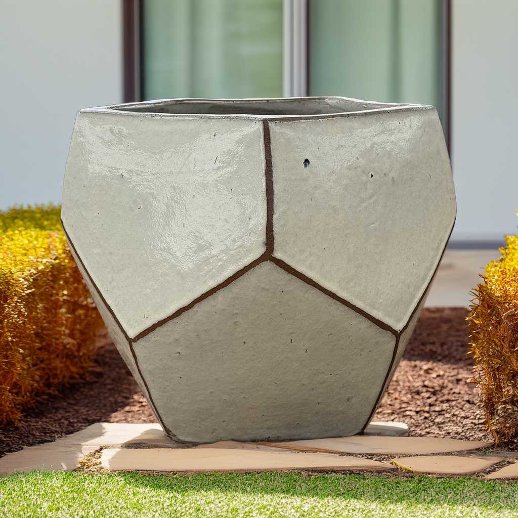 Faceted geometric polygon ceramic planter in cream with brown accents, featuring sharp edges and a modern, sculptural design