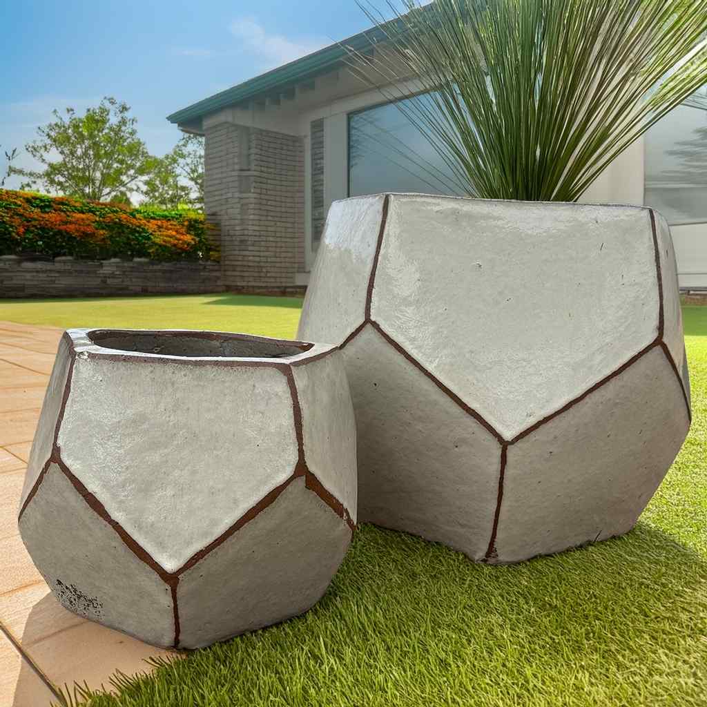 Faceted geometric polygon ceramic planter in cream with brown accent details highlighting its angular design