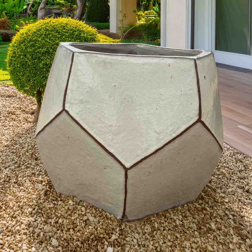 Faceted geometric polygon ceramic planter in cream with brown accents, featuring sharp edges and a modern, sculptural design