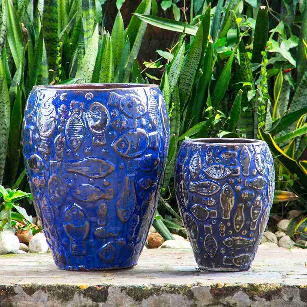 Ceramic planter with embossed aquatic design in blue, highlighted by black accents
