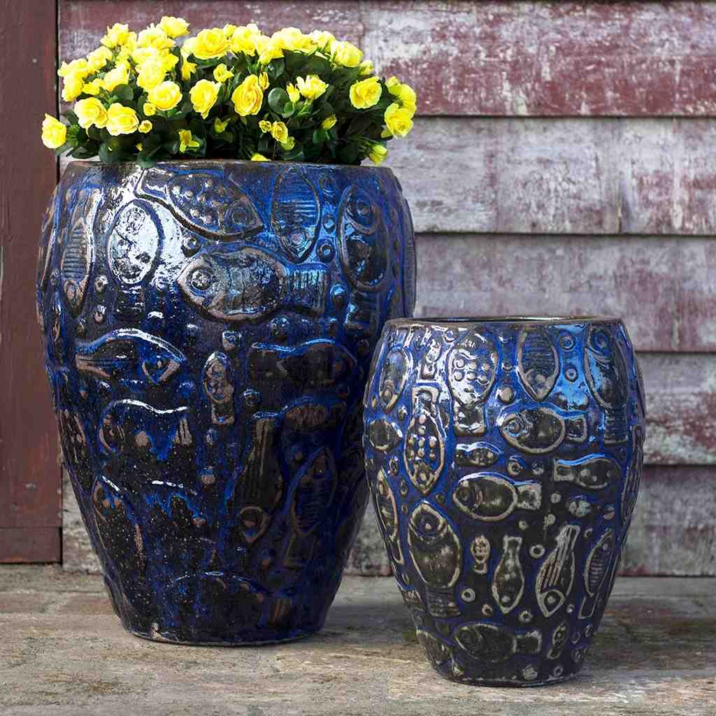 Ceramic planter with embossed aquatic design in dark blue, highlighted by black accents