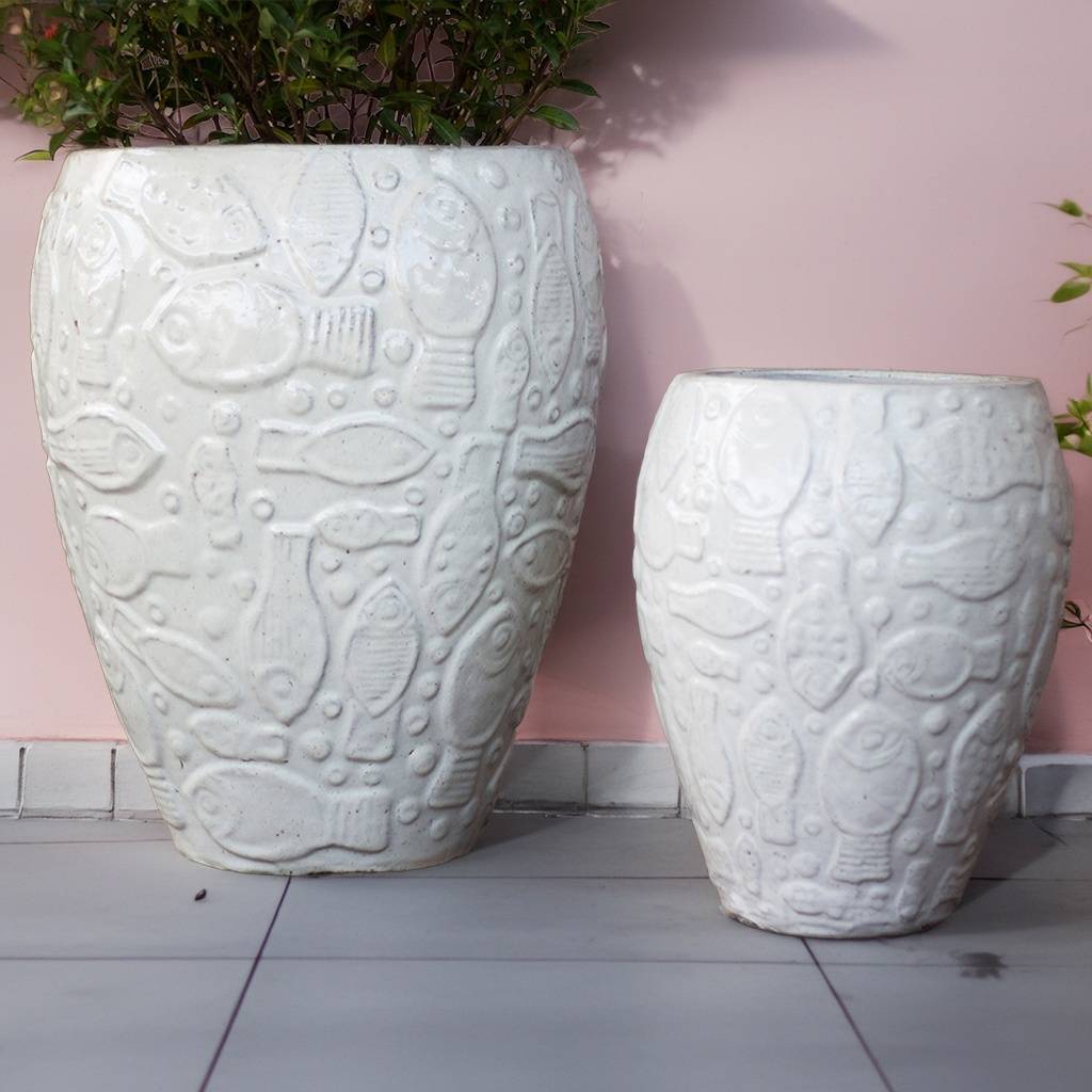 White ceramic planter with an embossed aquatic design