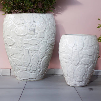 White ceramic planter with an embossed aquatic design