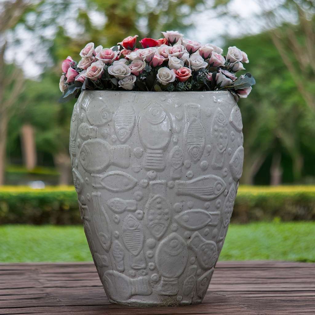White ceramic planter with an embossed aquatic design