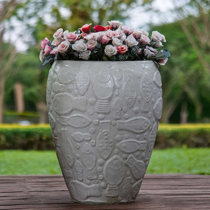 White ceramic planter with an embossed aquatic design