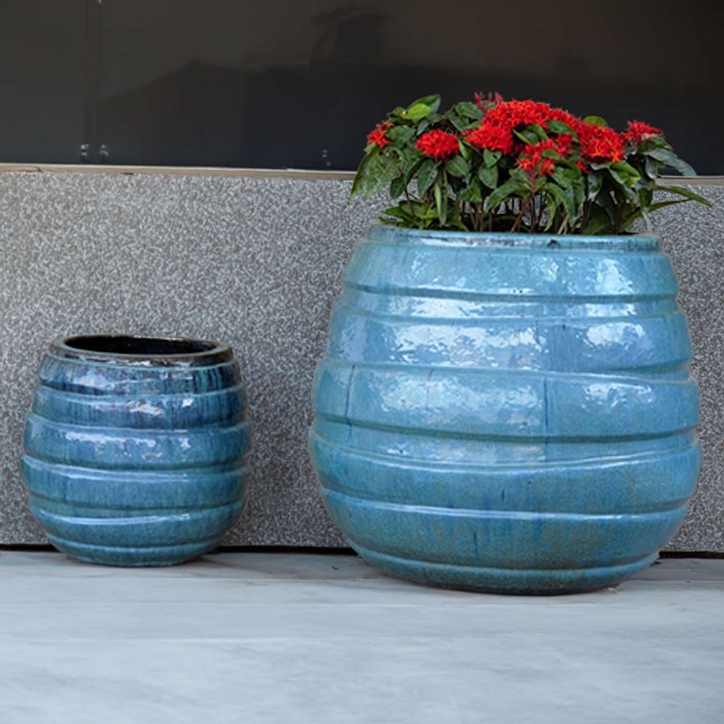 Glossy blue ceramic planter featuring bold horizontal stripes