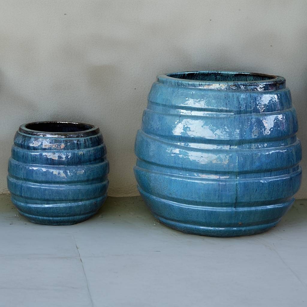 Glossy blue ceramic planter featuring bold horizontal stripes