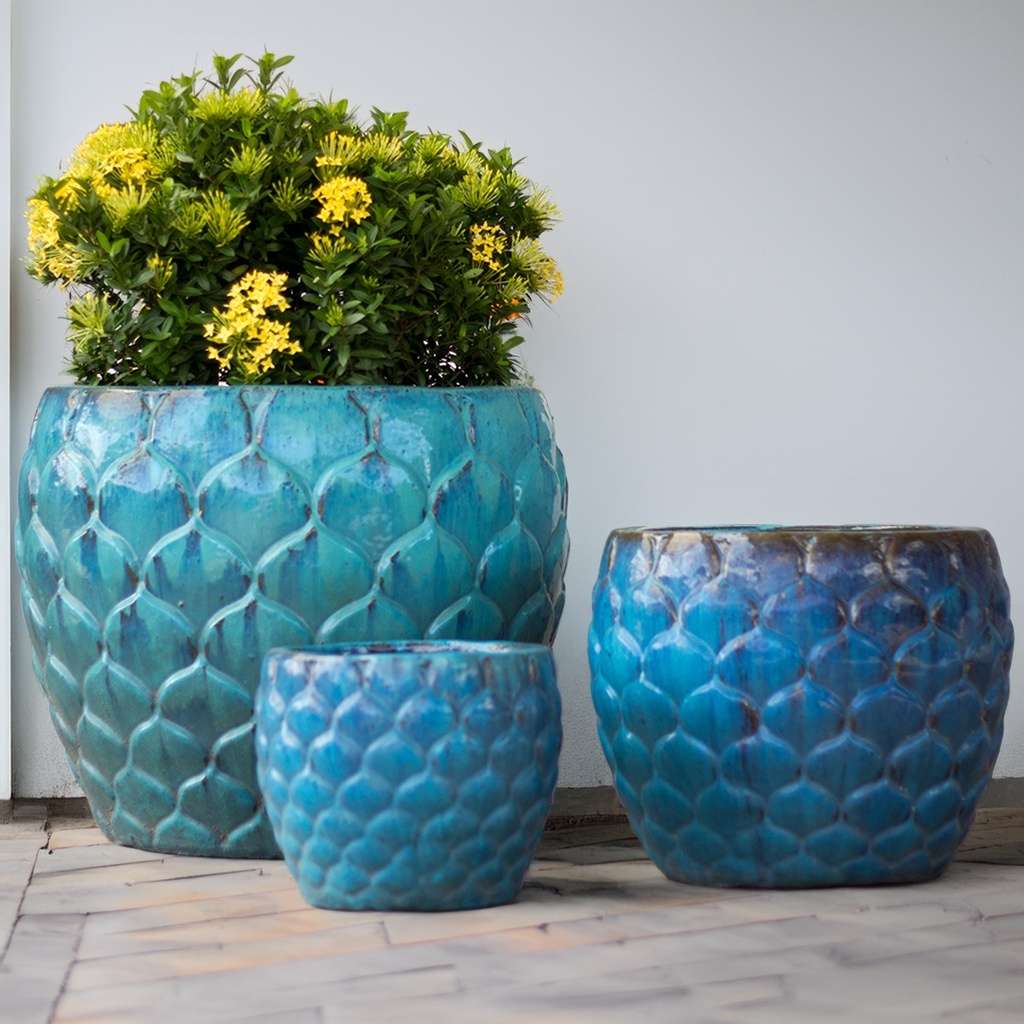 Aqua blue scalloped ceramic planter with a delicate, textured edge