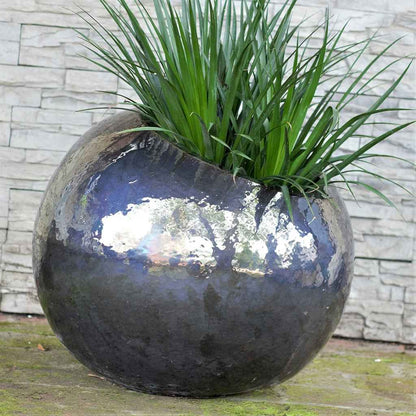 Glossy blue-gray tilted round ceramic planter with a smooth, modern finish