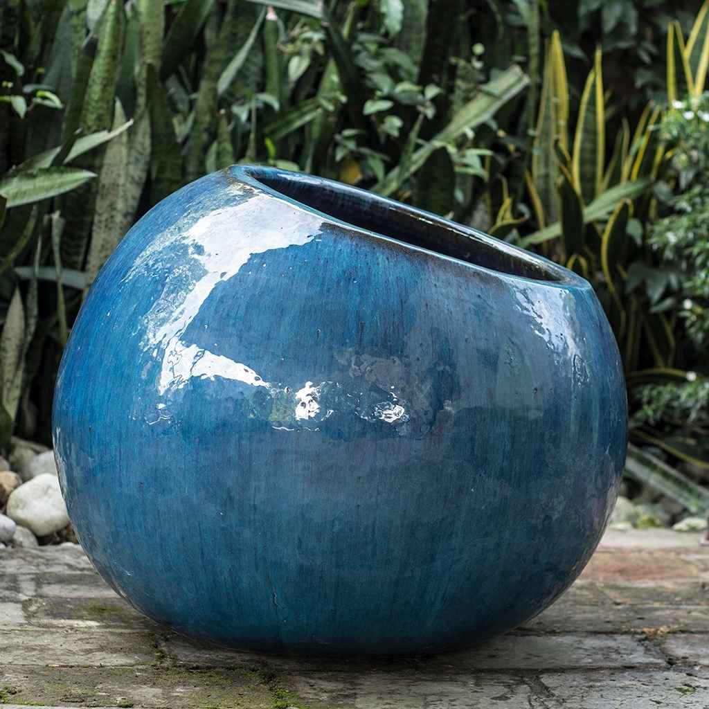 Wholesale  Tilted round ceramic planter with a glossy blue finish, featuring a unique angled design