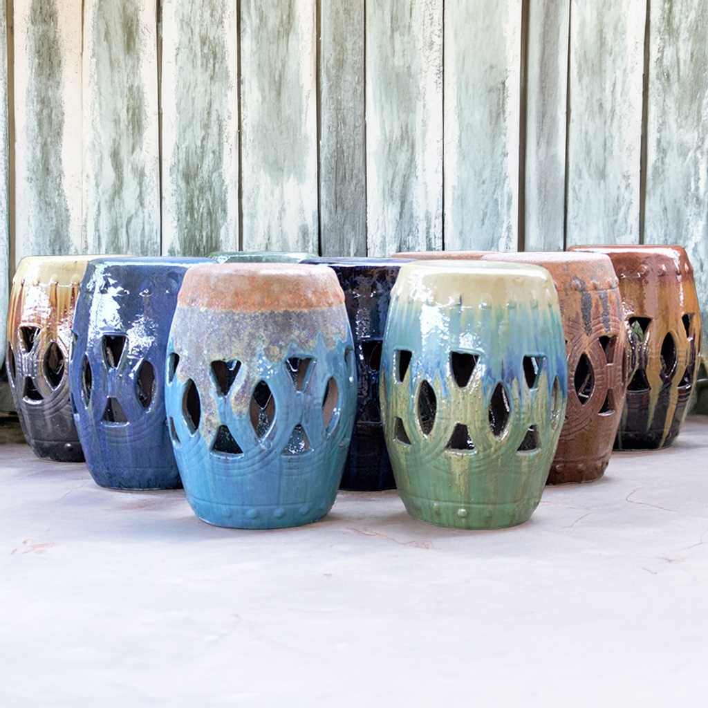 Ceramic garden stools in various hues, featuring gradient and solid colors including light blue, deep blue, green, earthy brown, and cream tones
