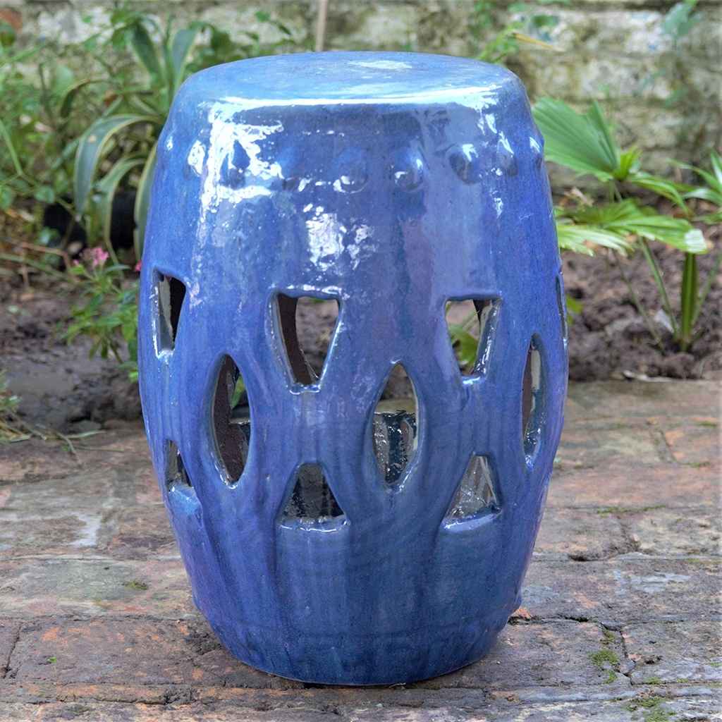 Ceramic garden stool in glossy blue featuring a decorative cut-out design