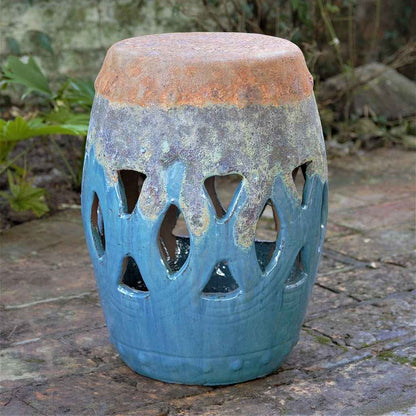 Ceramic garden stool featuring a lattice cut-out pattern in vibrant blue with mottled grey-blue and a distressed top, creating a textured, aged appearance