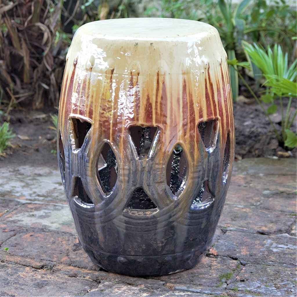 Multi-toned ceramic garden stool in glazed brown with a flowing beige-cream effect and distinctive openwork cutouts for added texture and style