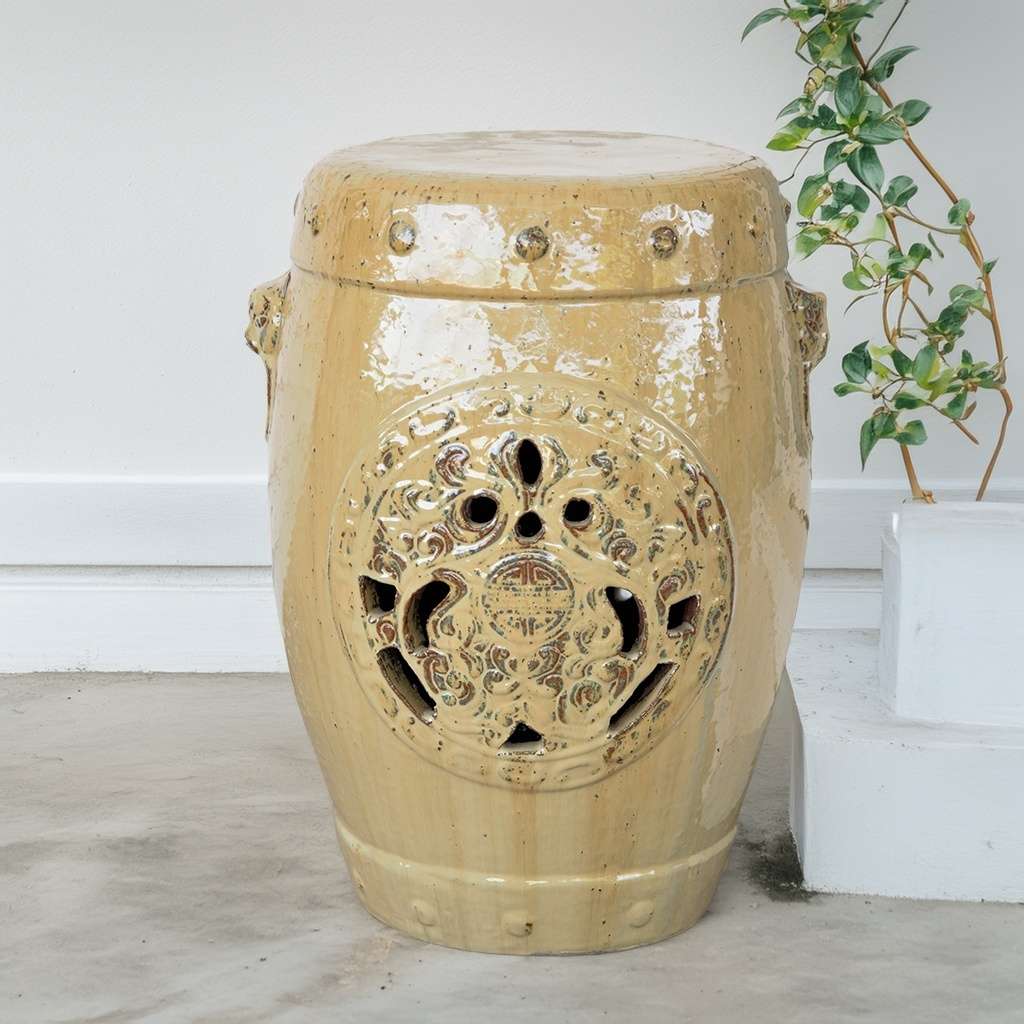 Ornate ceramic garden stool in glazed beige, featuring intricate detailing and a smooth, elegant finish