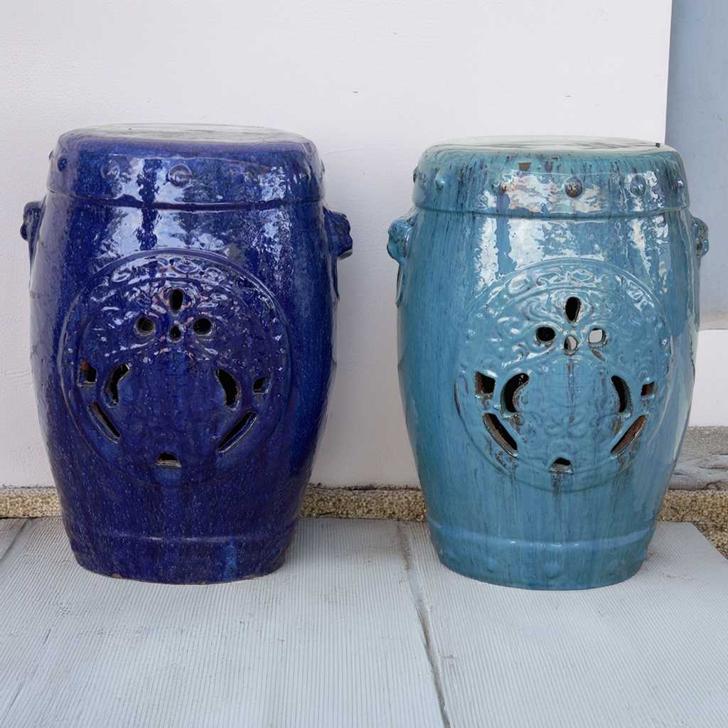 Set of 2 ornate ceramic garden stools featuring intricate designs in glazed dark and light blue 