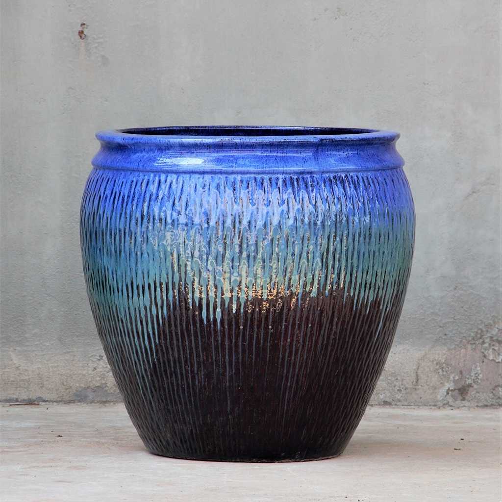 Barrel-shaped ceramic pot in blue with brown accents
