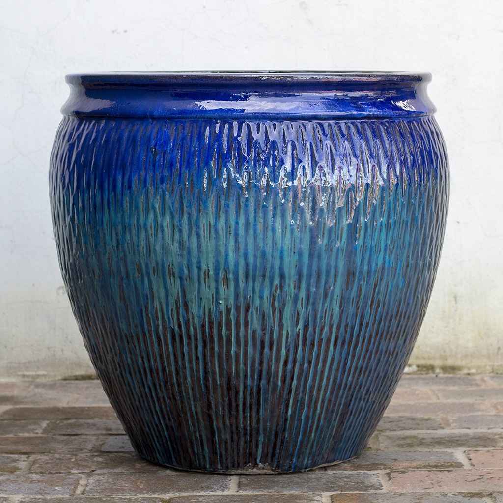 Wholesale Barrel-shaped ceramic pot in blue with brown accents highlighting its textured curves