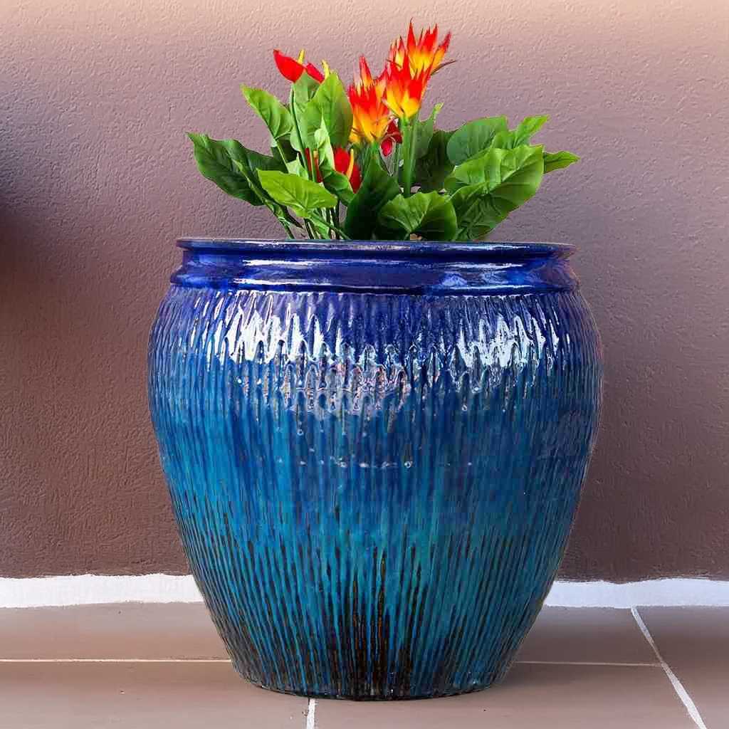 Barrel-shaped ceramic pot in blue with brown accents