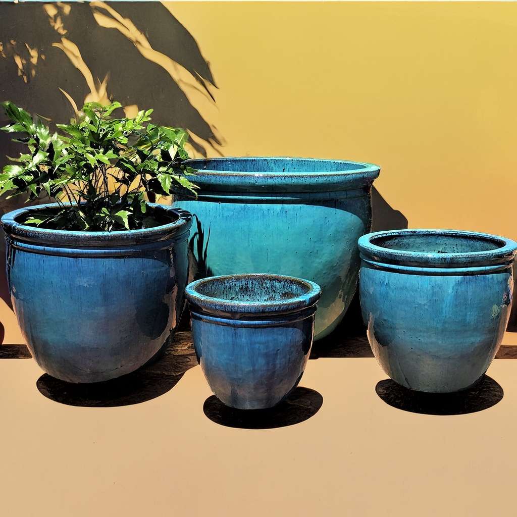 Classic rounded ceramic planter with a smooth blue glaze 