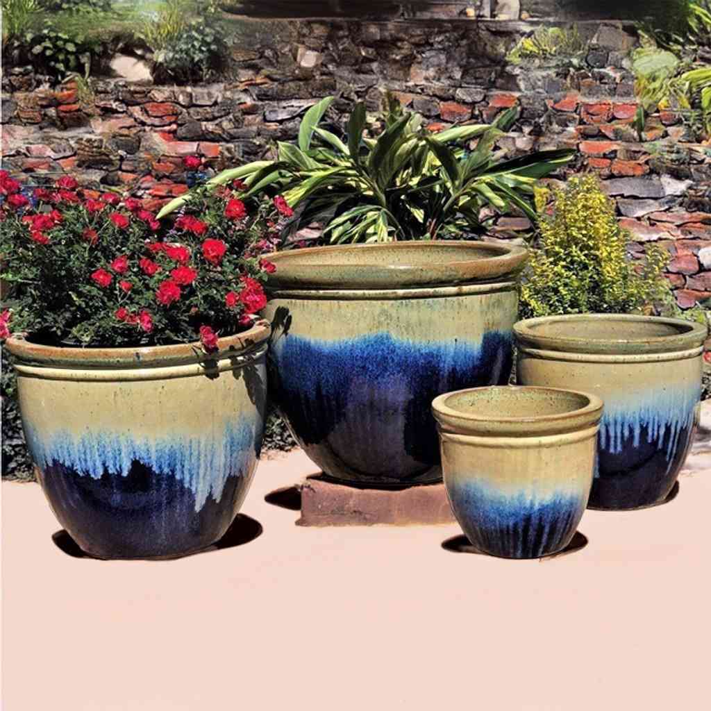 Classic rounded ceramic planter in dark blue with light blue and beige dripping glaze