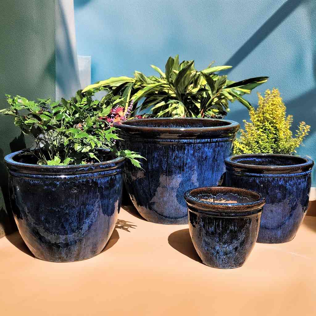 Classic rounded ceramic planter with a smooth blue black glaze 