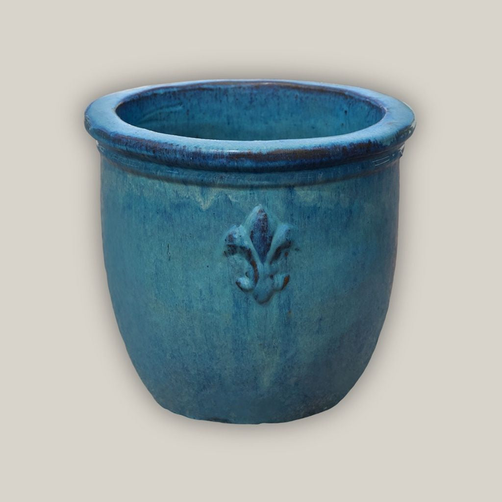 Round ceramic planter featuring elegant fleur-de-lis embossing and a marble green finish for a classic, refined look