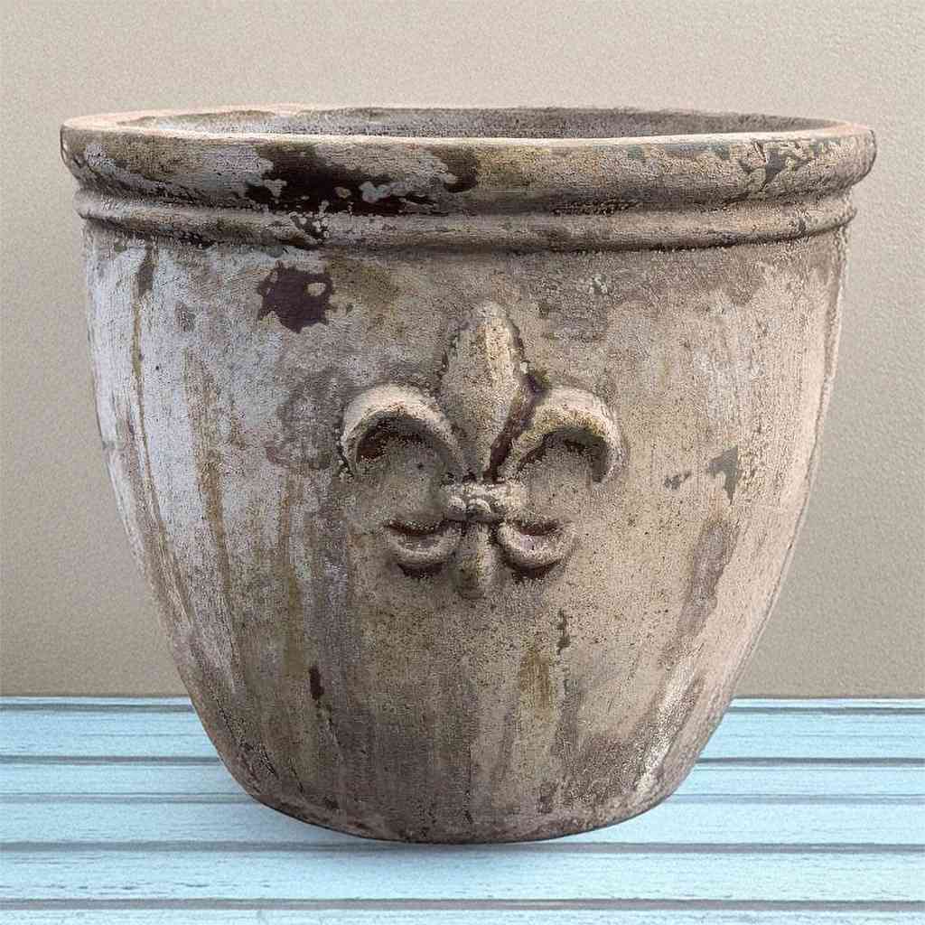 Round ceramic planter featuring elegant fleur-de-lis embossing in antique bronze with an aged patina