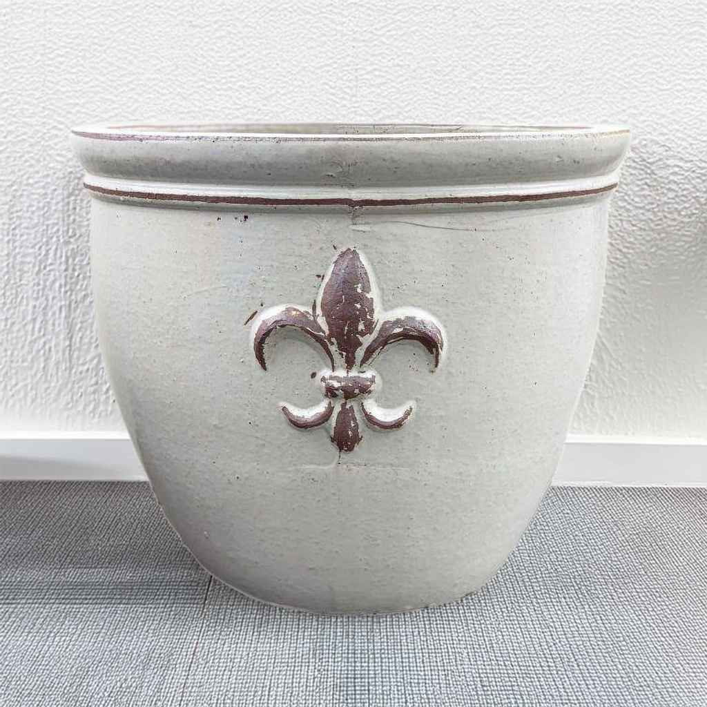 Round ceramic planter featuring elegant fleur-de-lis embossing in matte white finish